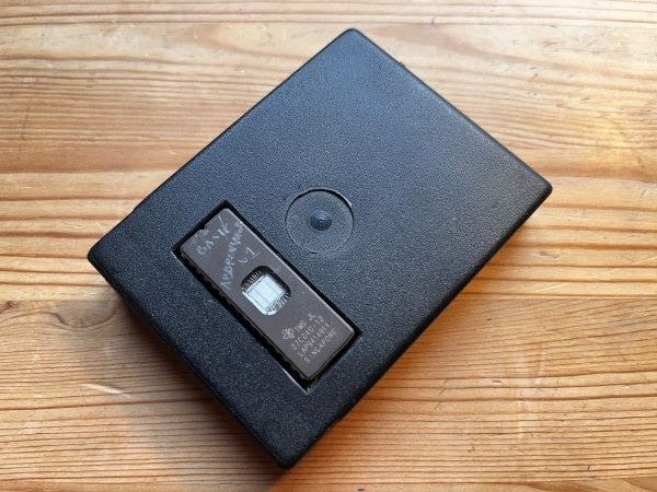 A photo of the black cartridge case prototype with the EPROM window cut out